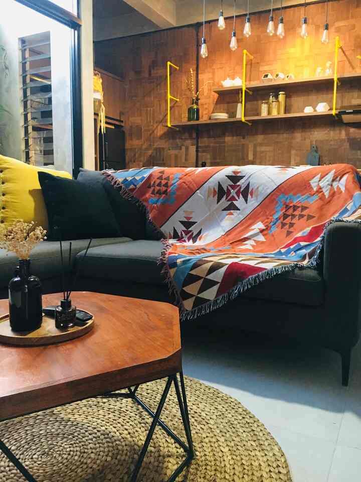 Cozy open-plan living room and kitchen with wood tones and natural colors