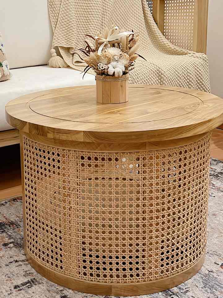 Wood tone and white living room featuring rattan chairs and round coffee table with natural and cozy atmosphere