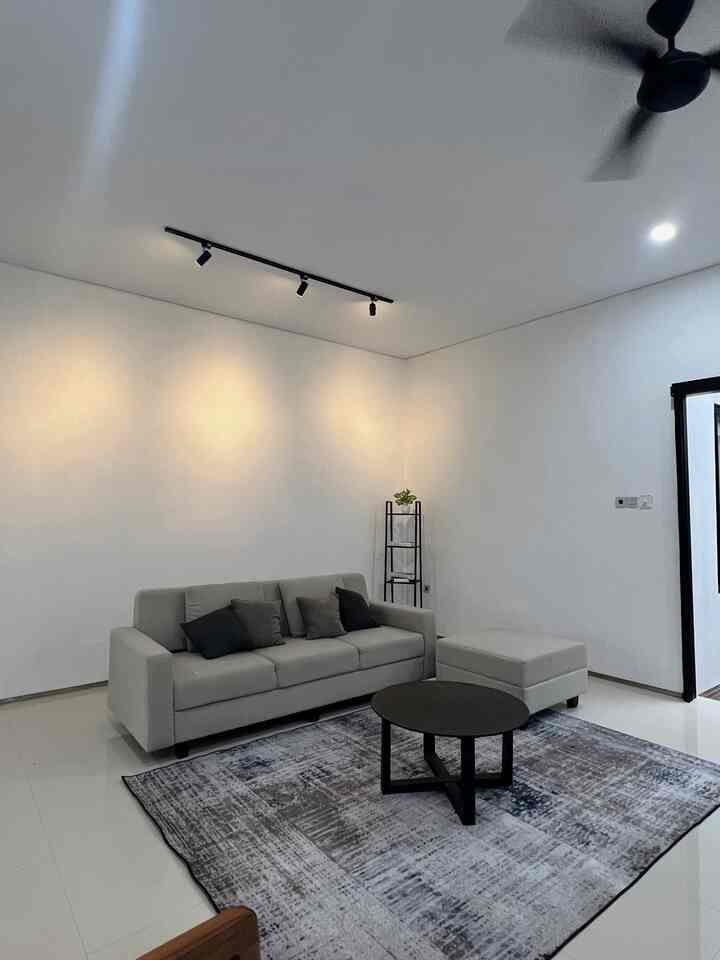 Simple and minimal Nordic living room in white and gray tones featuring sofa, carpet, and coffee table with a clean ambiance