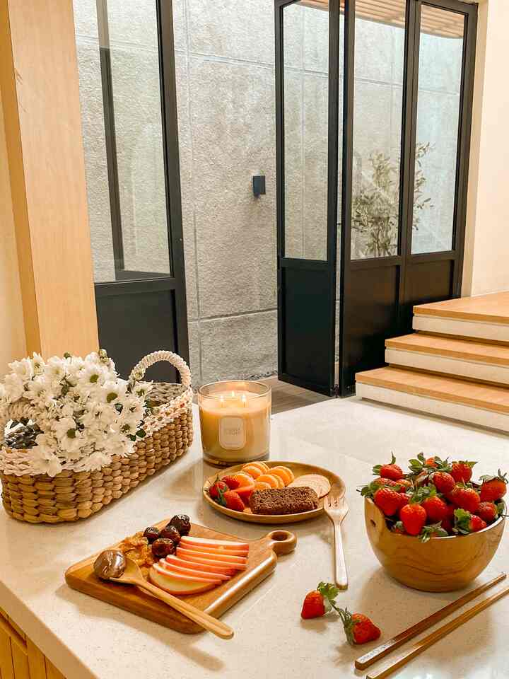 Natural color and wood tone kitchen corner featuring fruit and storage basket in a cozy space