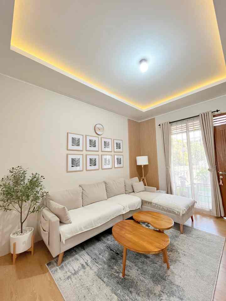 Light brown wood-toned coffee table and neutral beige sofa in a simple Japandi style living room