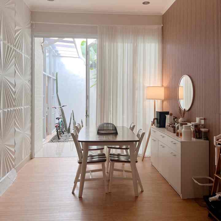 Natural brown wood tones and white hues in a dining room featuring a sideboard and dining table with a cozy atmosphere
