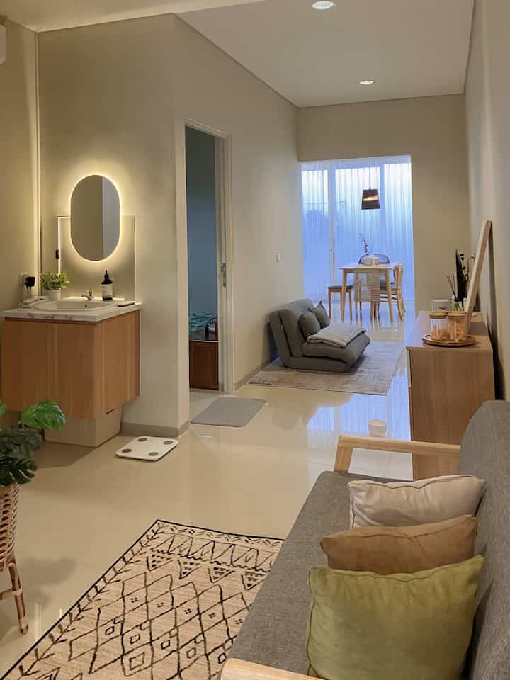 Beige and natural wood tone open plan living and dining room with minimal, simple interior design