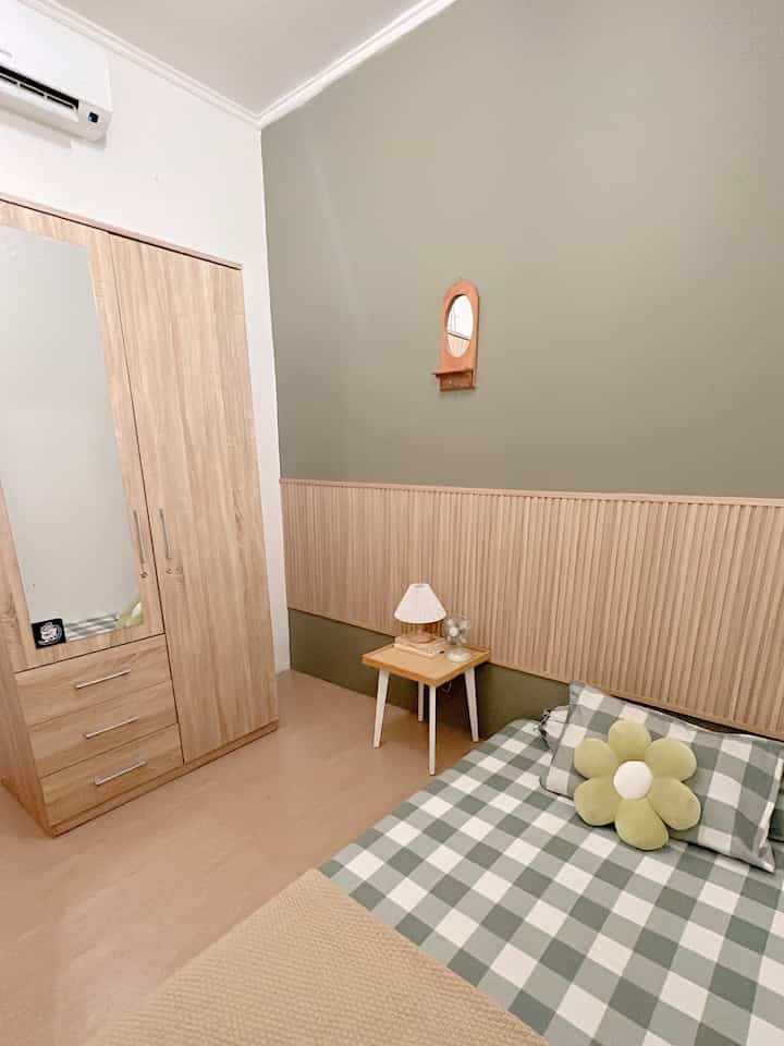 Natural color and wood tone kids' room featuring bed and nightstand in a cozy bedroom space