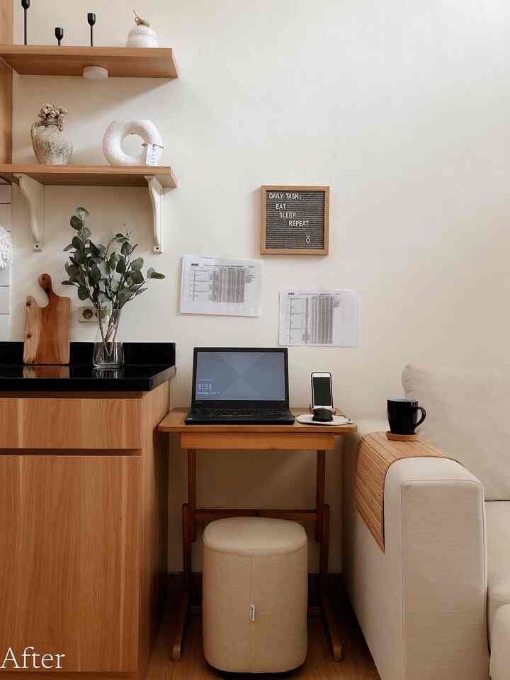 Beige and wood-tone small workspace with compact desk, stool, and beige sofa in a cozy setting
