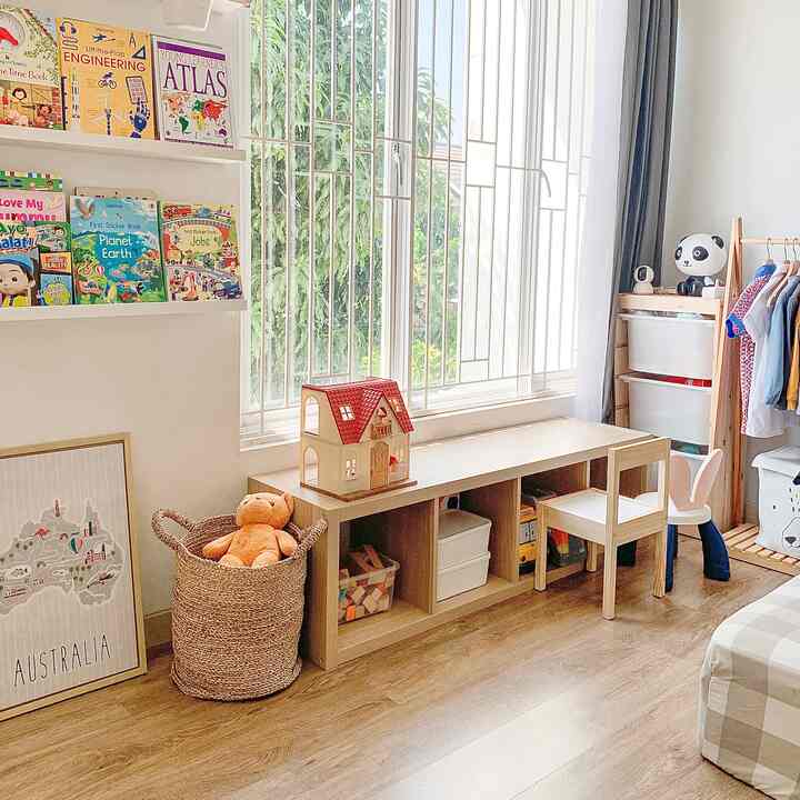 Natural wood tone and natural colors in a kids' room reading corner, featuring a child-sized desk and toy storage in a tidy space