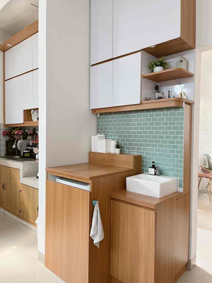 White and wood tone narrow, long service area featuring a ceramic sink and wooden cabinets in a clean natural modern style