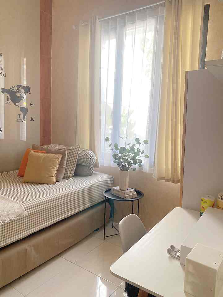 White and wood tone kids' room featuring a bed and desk by a large window with cozy, natural atmosphere