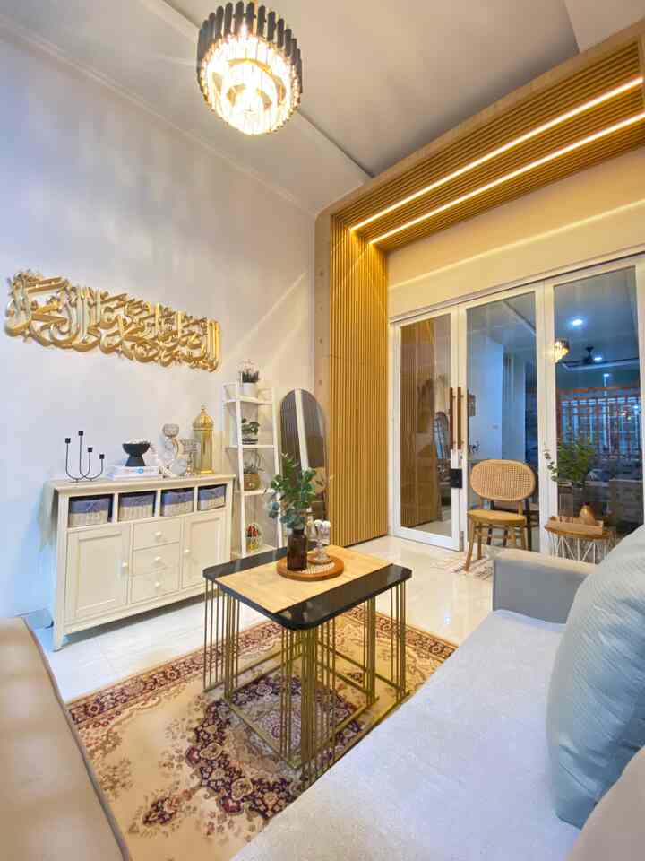 Natural-tone living room with white walls and wood-tone storage, featuring simple furniture and accent LED strip lighting
