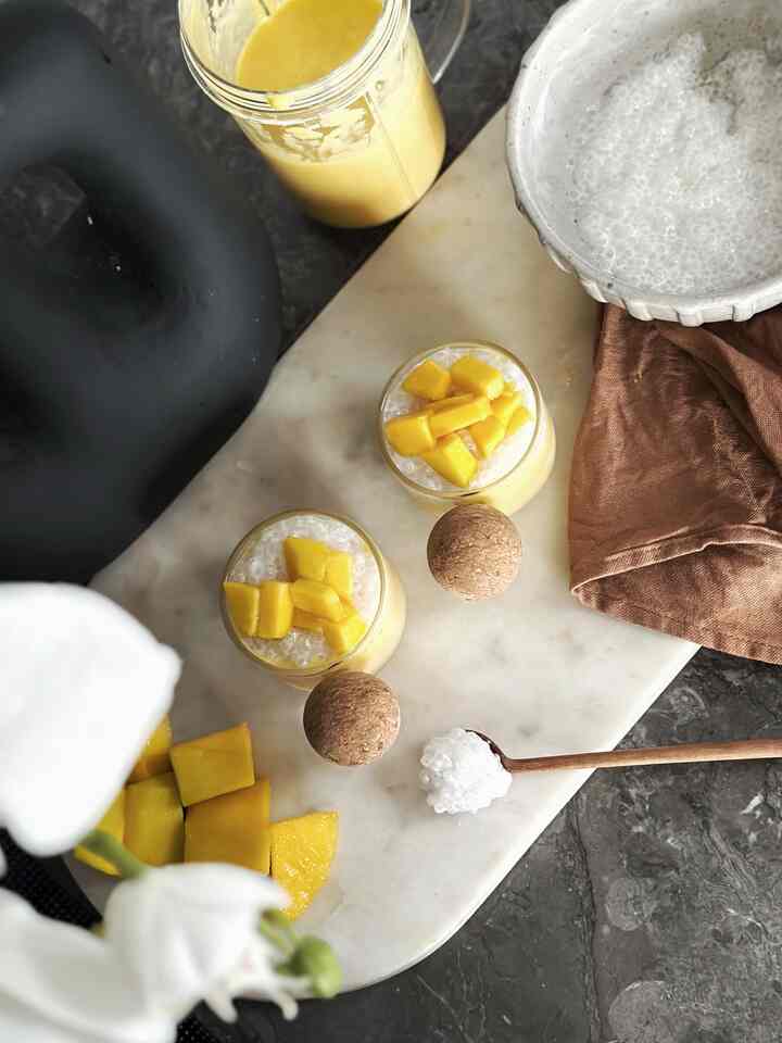 A yellow and beige toned kitchen scene featuring marble cutting board with mango desserts and kitchen accessories creating a cozy atmosphere