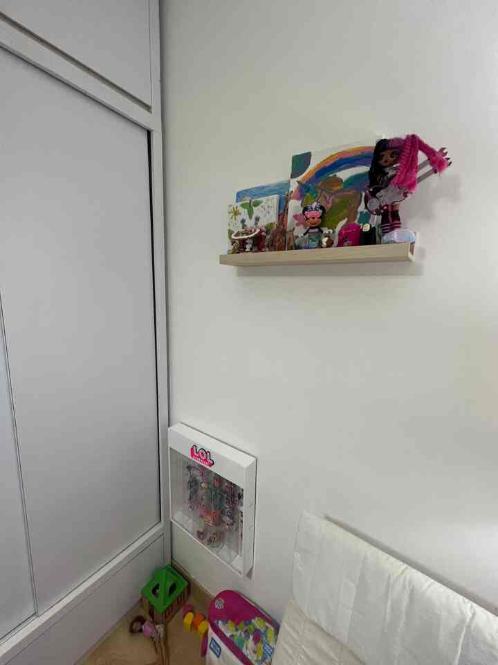 A simple, natural-toned kids' room featuring toy storage shelf and children's toys creating a cozy atmosphere