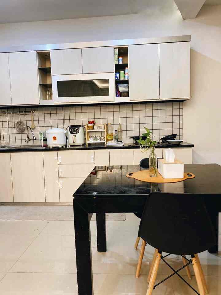 Bright wood tone and black accented kitchen and dining table, simple modern styled space