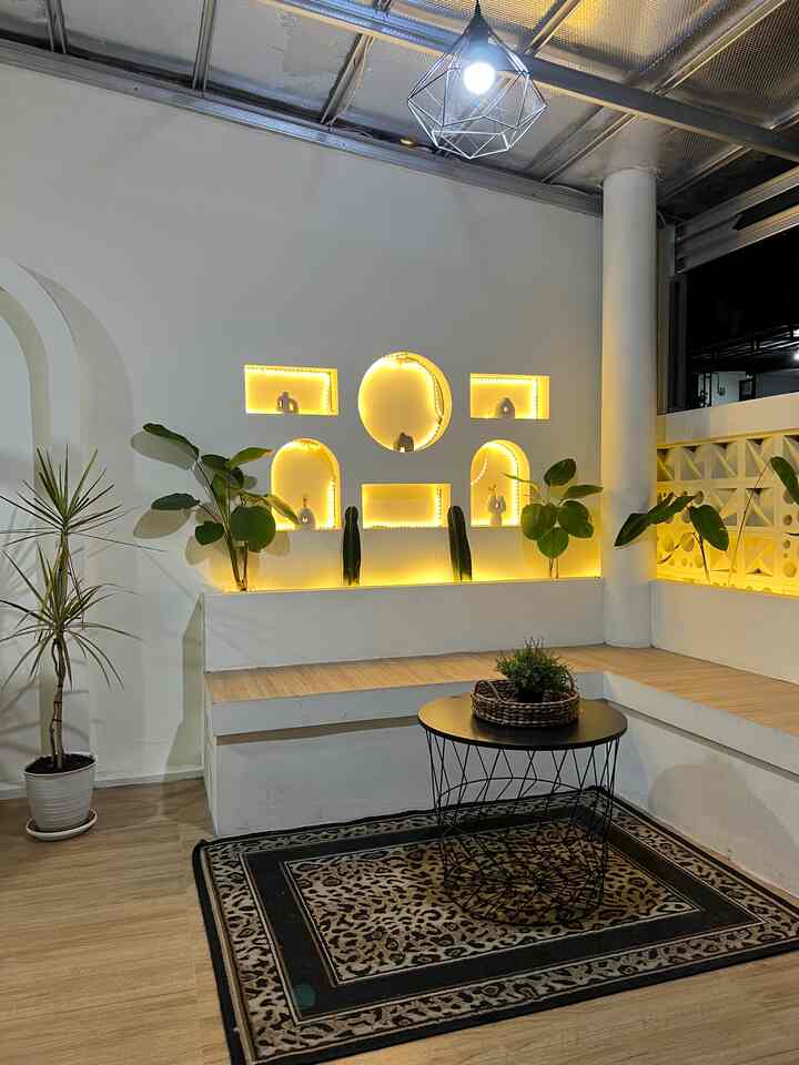 Warm yellow-lit natural terrace featuring bench seating and plants with cozy atmosphere