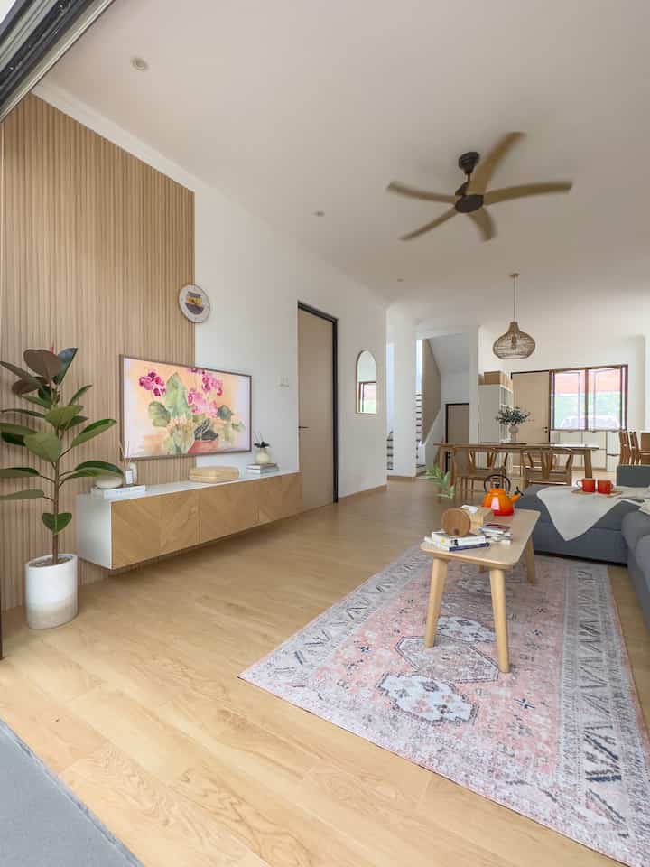 A warm and comfortable living room is a must. Because all family members spend the most time in this room after returning from all activities outside the home. The aim of using a ceiling fan is to save more electricity, although there is still a 2PK AC in this room, but usually the AC is only turned on at night. There are also lots of openings, because the folding door is quite wide, but because the canopy roof is transparent, it gets quite hot too.

The furniture in this room is mostly from IKEA, such as the sofa, floating TV cabinet, coffee table and prints. Still using natural wood and earth tone pallette, occasionally there is a splash of color in the decoration so it's not monotonous. As much as possible, don't have too many unnecessary decorations in this room, so that it's easier to clean every day and the appearance isn't too busy so it's nicer to look at.

#livingroomstyling
#livingroomdecor
#livingroommakeover
#scandinavian
#japandi
#koreanhome
#nordichome