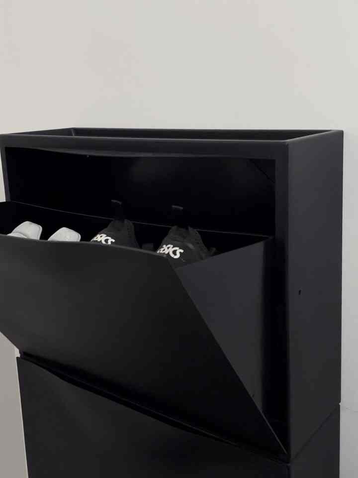 Black-toned entrance space featuring a sleek modern shoe cabinet neatly arranged