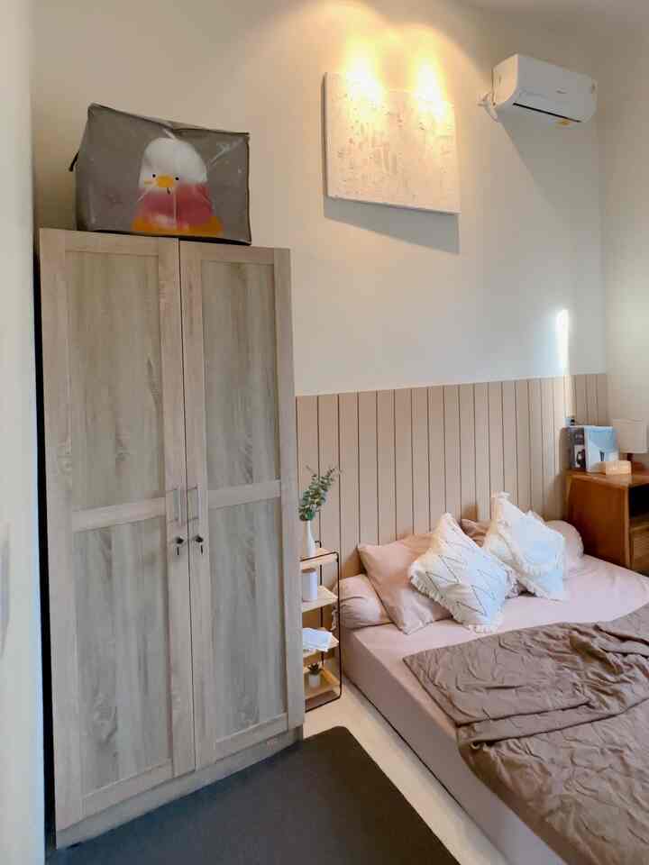Natural-toned bedroom with brown and beige bed and wardrobe creating a cozy atmosphere