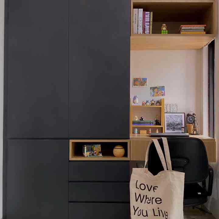 Minimal style home office featuring white walls and wood tone wardrobe with integrated desk and shelving