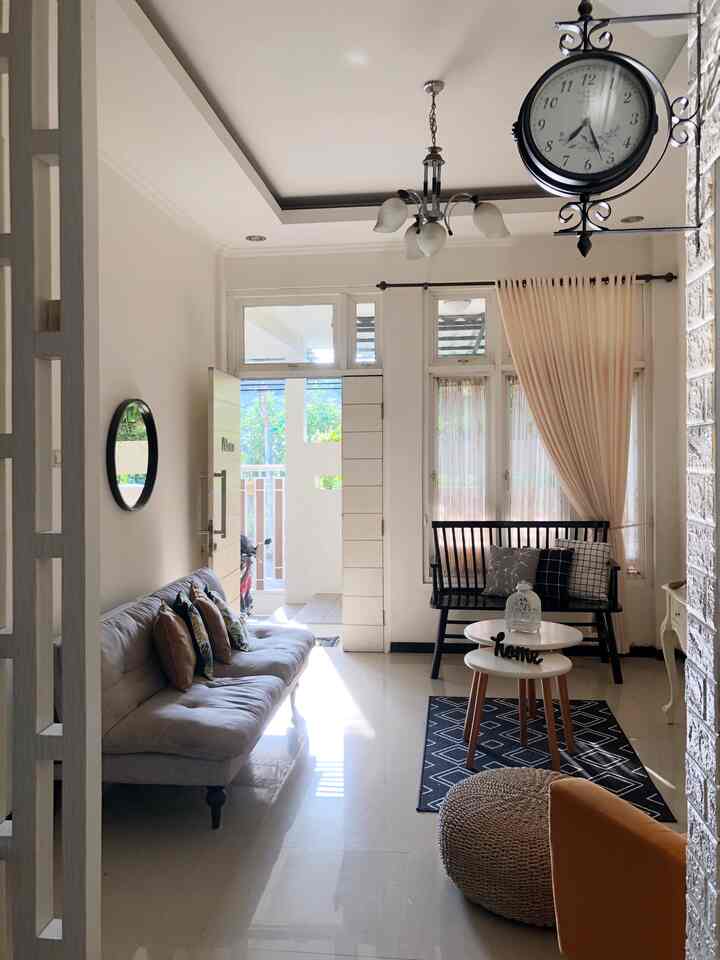 White and brown toned living room featuring sofas and coffee tables with a simple, natural atmosphere