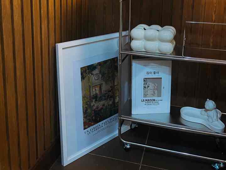 Vintage vibe small corner with dark brown wood panel wall and cream tray decor