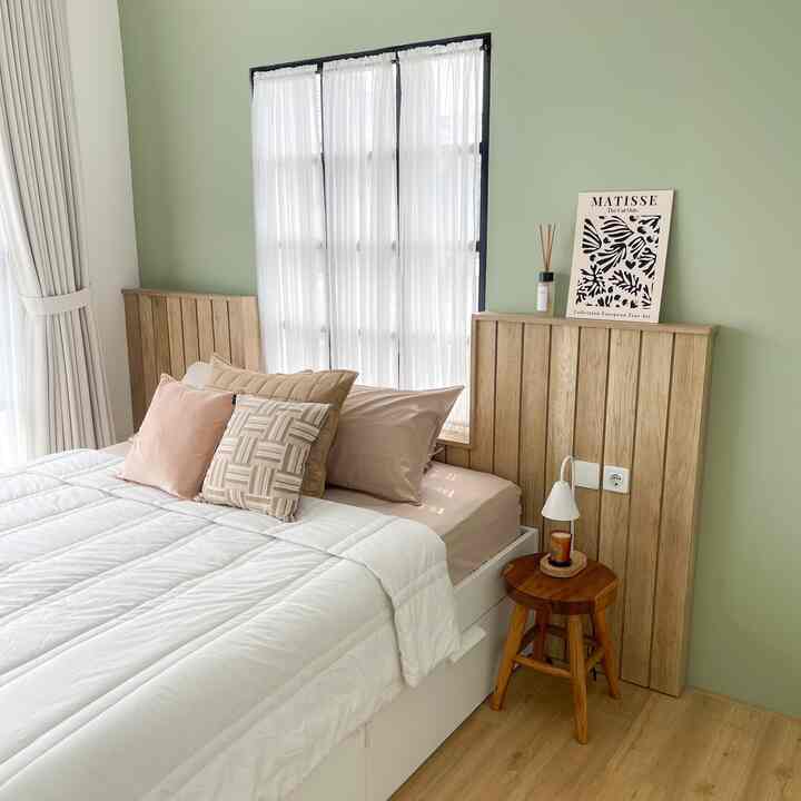 Soft white and wood tone bedroom featuring bed and wooden stool in a natural, cozy atmosphere