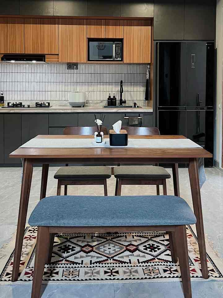 Modern open dining room and kitchen with wood tones and black monotone color scheme