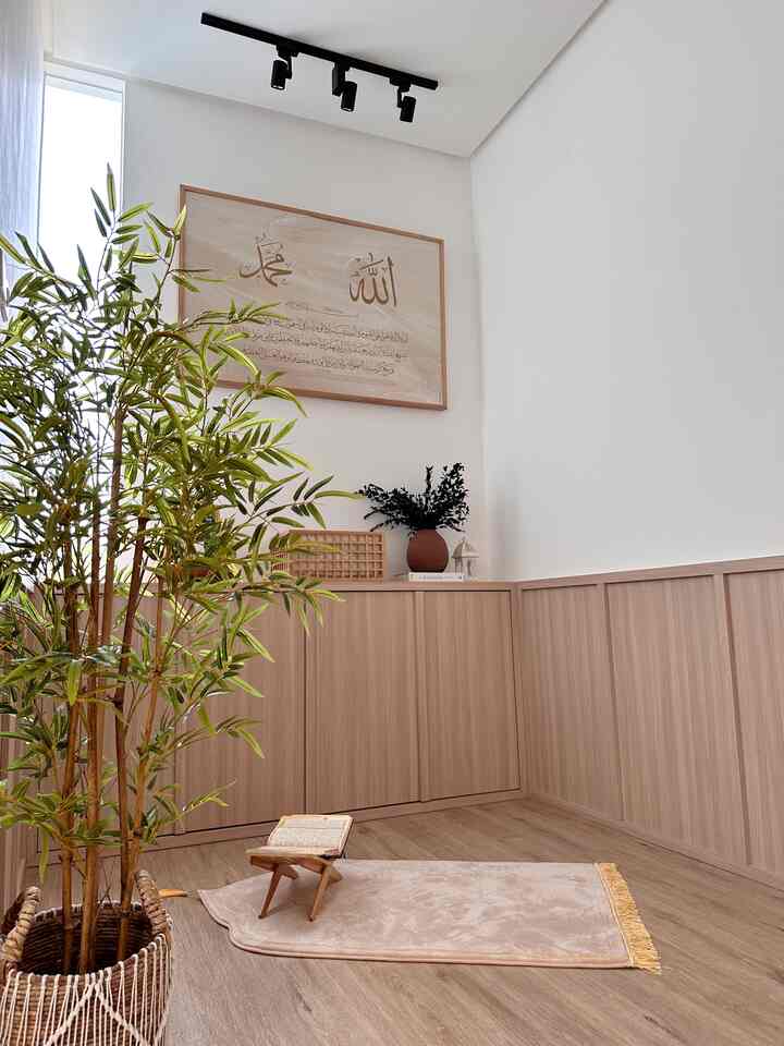 Natural-colored small prayer room featuring wooden cabinetry and a green plant, creating a tranquil Japandi atmosphere