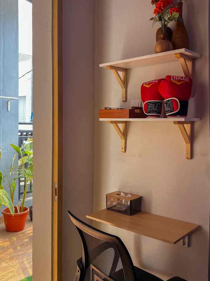 Cozy workspace with wood tones and natural light overlooking a small balcony