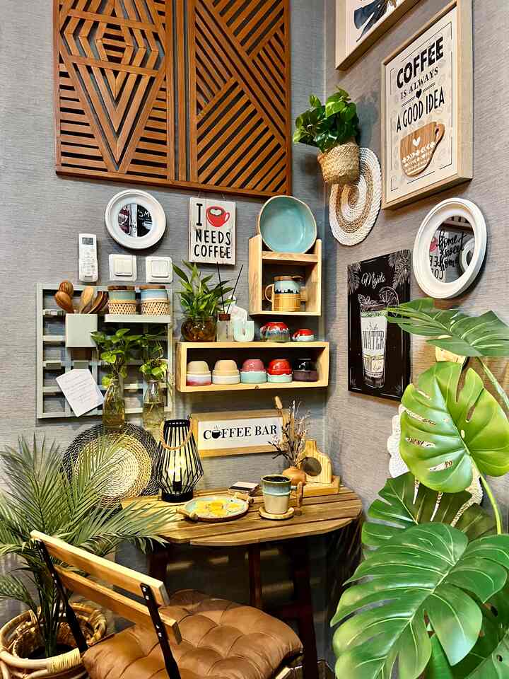 Natural wood tone small corner space with plants, decorated with coffee cups and framed art for a cozy home cafe