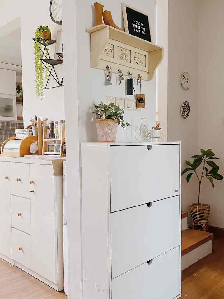 White and wood tone entrance featuring a shoe cabinet and key storage area with a cozy and organized feel