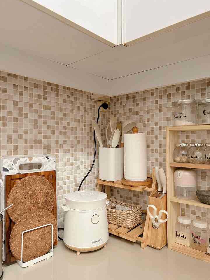 Natural wood tones and white dominate this kitchen corner featuring neatly arranged cooking utensils and storage items
