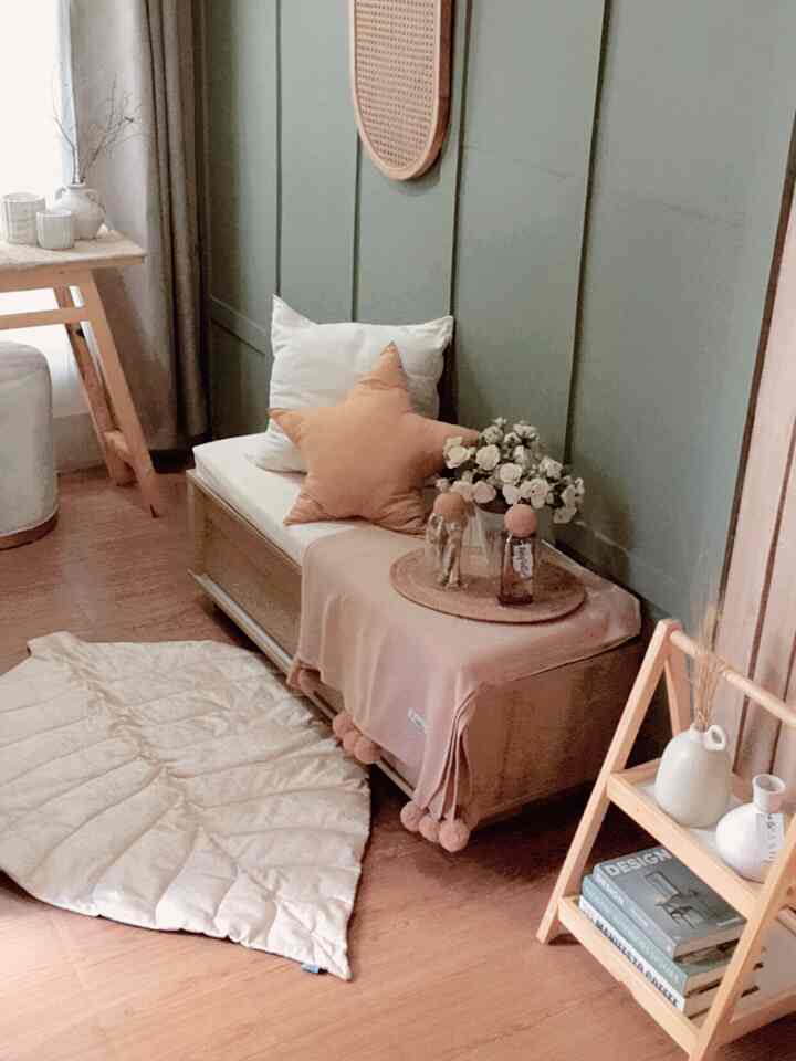 Beige and green toned entrance foyer featuring cushions and carpet with cozy natural ambiance