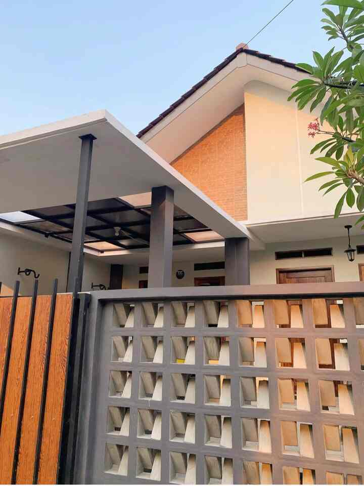 Gray and brown toned Scandinavian style house facade featuring flat canopy and lattice wall creating a neat entrance area