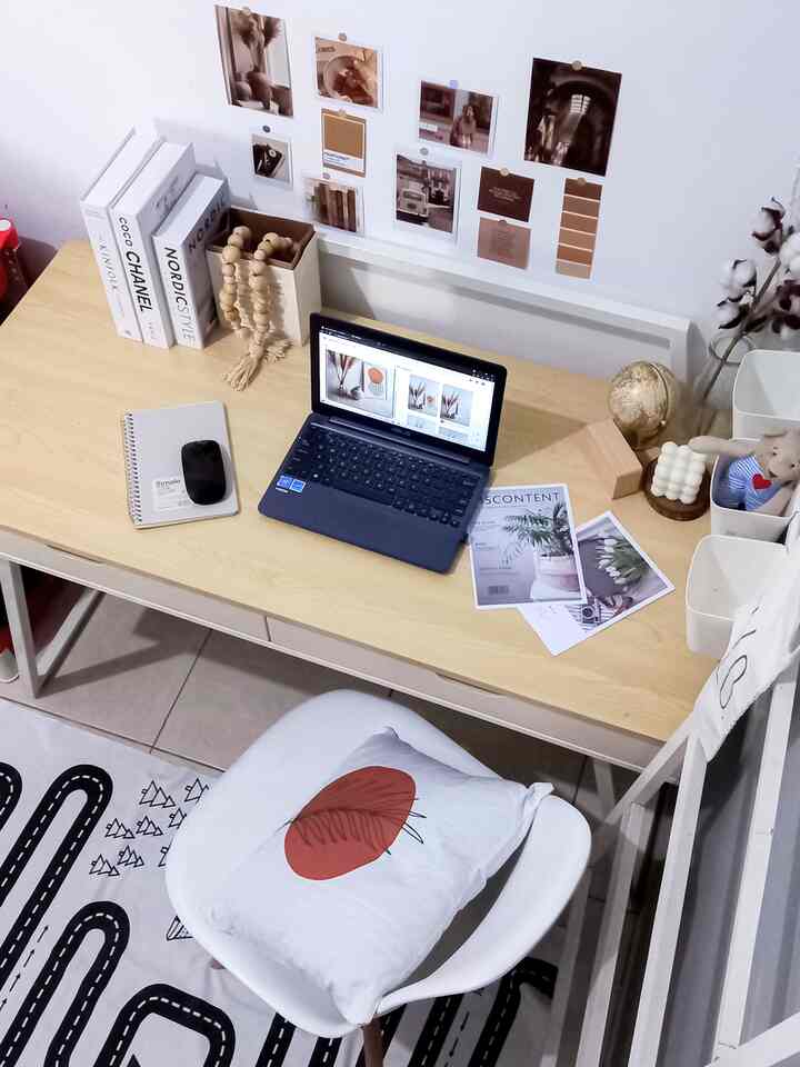 Natural wood tone kids' room featuring a simple Nordic style study desk and small chair with neat wall decor