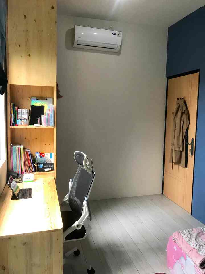 White and wood tone kids' room featuring a desk and office chair creating a cozy home office space