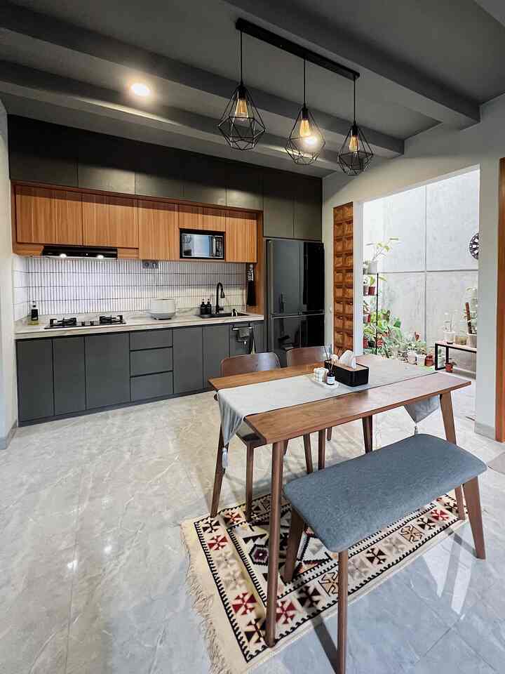 Monotone and wood-toned industrial Japandi kitchen featuring wooden dining table and three chairs in a modern space