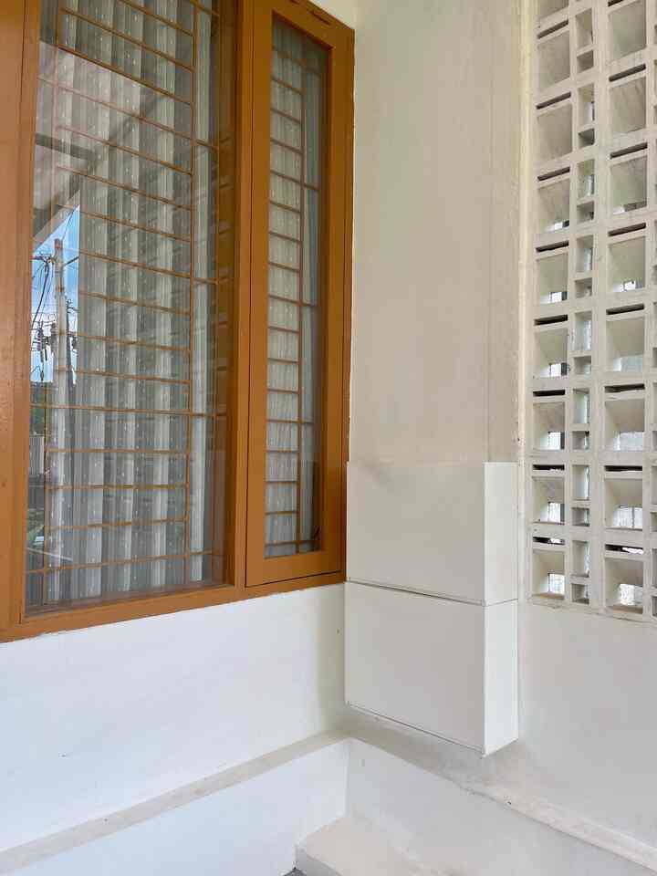 White and brown wood tone entrance featuring wall-mounted shoe cabinet with a clean and natural atmosphere