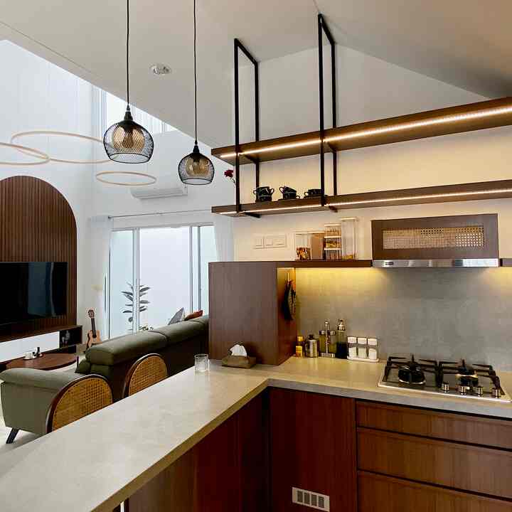 Modern kitchen and living room featuring natural wood tones and white elements with a clean, organized interior