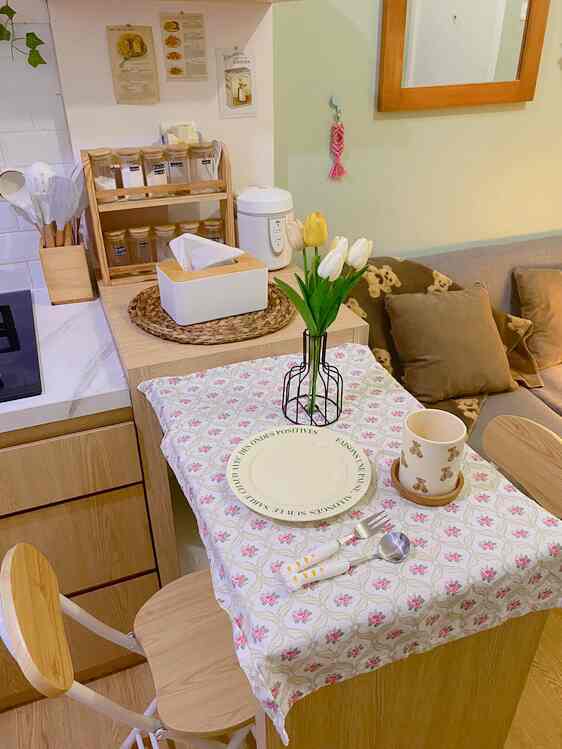 Bright wood tone and white pastel dining room featuring table, chairs, and minimal cozy decor