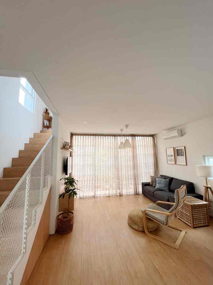 Natural wood tone and white open-plan living room with simple, clean Japanese minimalist style