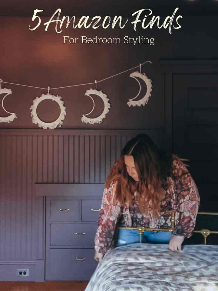 Moody purple-walled bedroom featuring gold bed frame and floral bedding with vintage boho accents