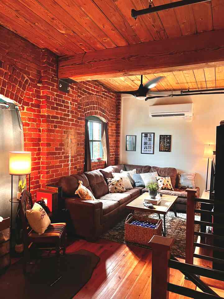 Loving the living room in my new loft apartment! The exposed brick and hardwood floors bring a naturally cozy feel to the space which I absolutely adore. #loft #brick #apartment #livingroom 