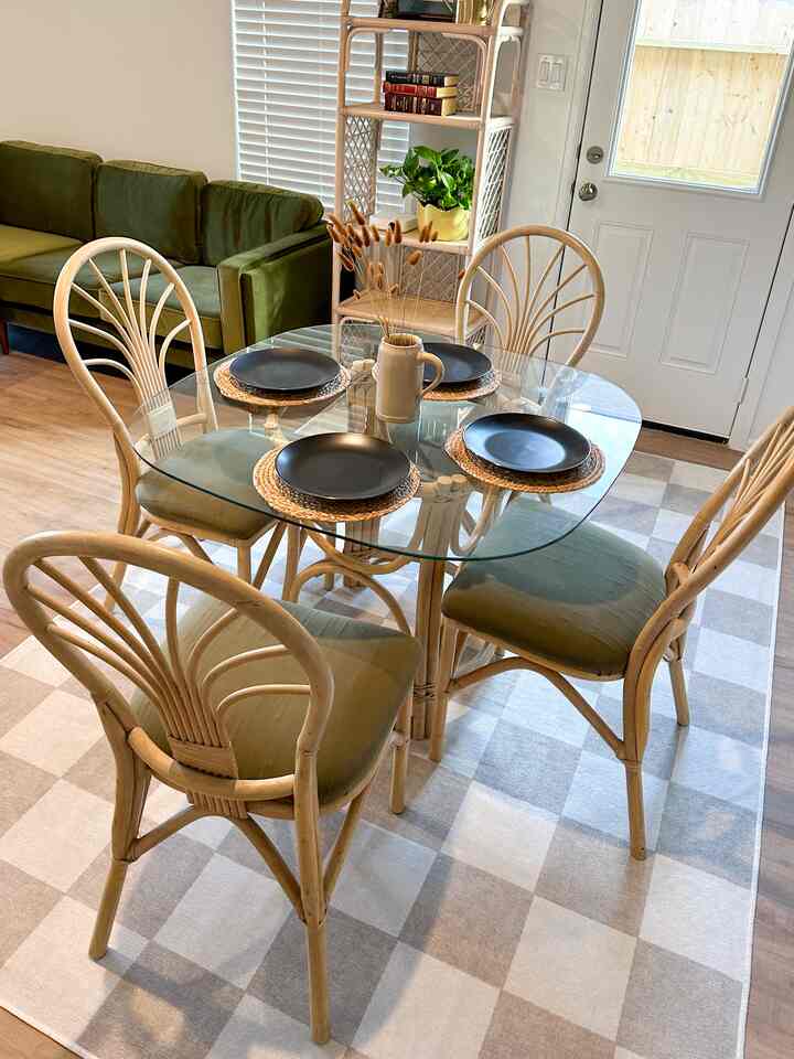 Natural brown-toned living dining area featuring bamboo table and chairs with cozy bohemian style