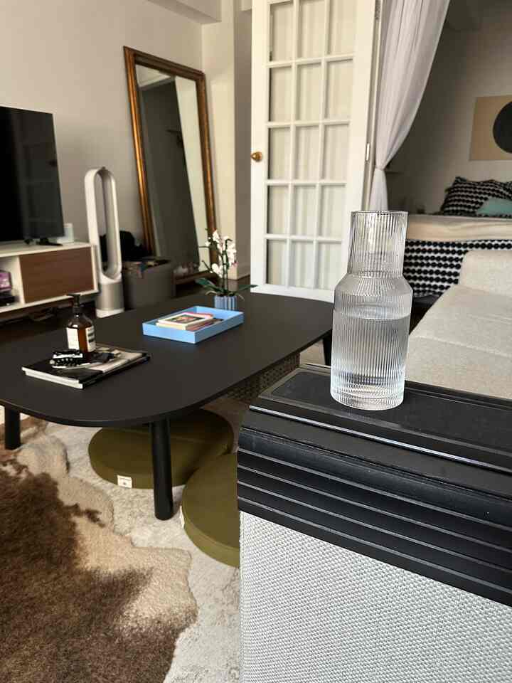 I looove my DIY oversized coffee table 🩶 in my small apartment, there isn’t enough room so I took an IKEA dining table and cut the legs to get the perfect table for my space. I really struggled to find one that's reasonably priced and big enough. #DIY #smallapartment #nyc