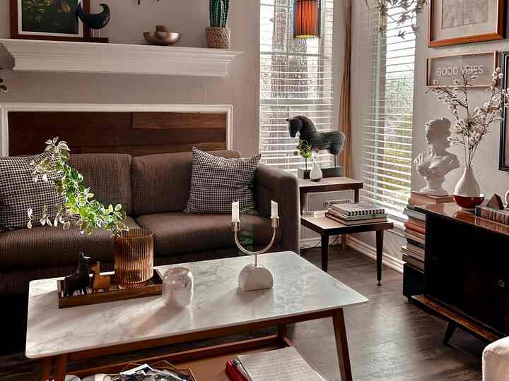 Natural brown toned living room featuring a styled coffee table with decorative objects in a cozy setting