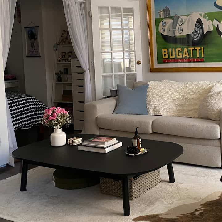 Neutral-toned living room with beige sofa and black coffee table, calm and natural atmosphere