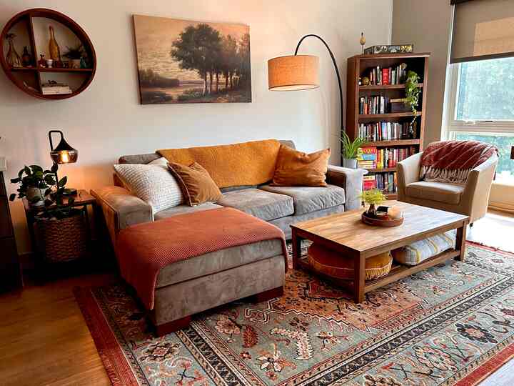 Natural warm-toned living room featuring beige sofa and wooden coffee table with cozy atmosphere
