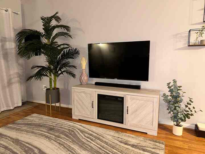 Boho Chic Modern Farmhouse decor styled media center in living room. Crofton, MD. #boho #modern #eucalyptus #marble #fireplaceconsole #storageinterior 