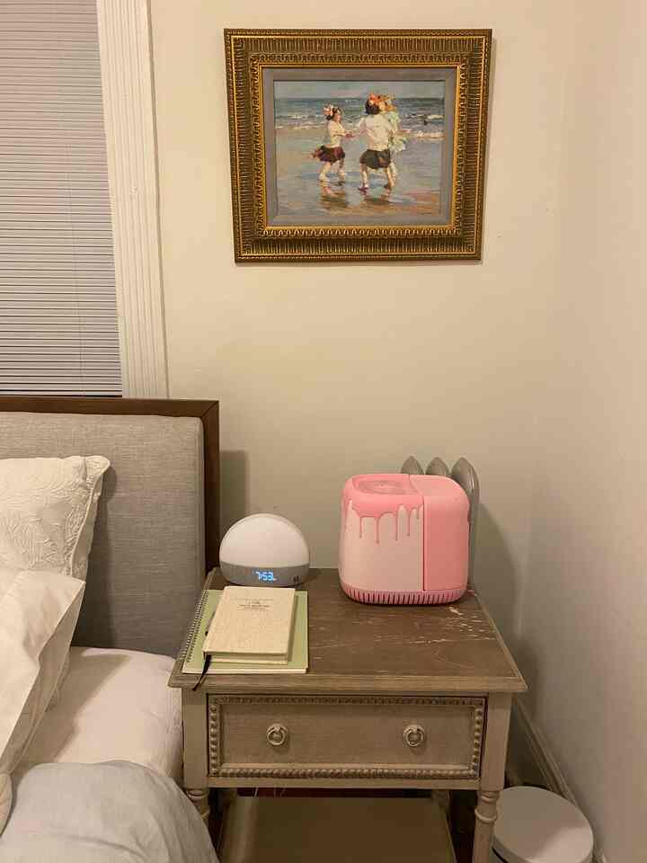 Simple and natural bedroom featuring bright white walls and a wooden brown nightstand