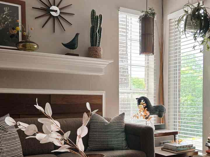 Natural toned living room featuring wood-tone sofa and disguised fireplace creating a warm atmosphere