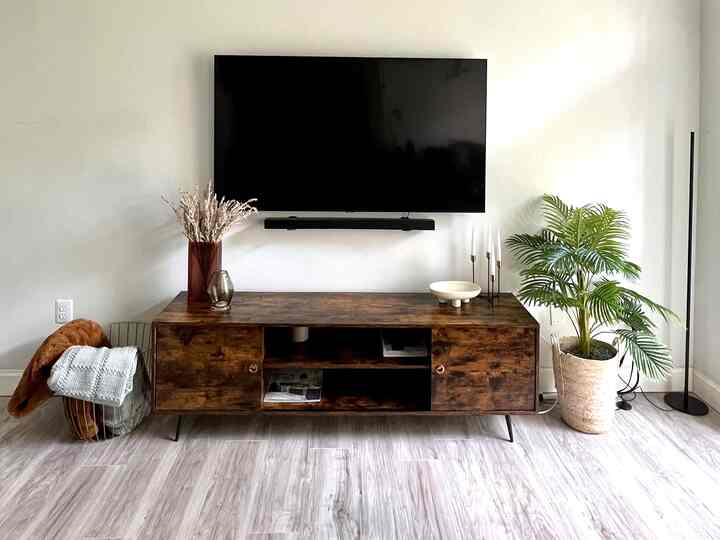 #livingroomstyling #mylivingroom  #livingroominterior my living room is still a work in progress, but it’s coming along nicely! Starting with styling the media stand. We’re transitioning into Fall, but i wanted to keep some warmth with the vases i chose, and colors of the throw blankets. The products are from At Home, Wayfair, and Target mainly. Although that palm plant will soon be replaced with a more seasonal piece, I’m still enjoying the look I’ve created so far. My ceilings are also 13ft tall! So I’m diligently planning how future artwork will be placed.